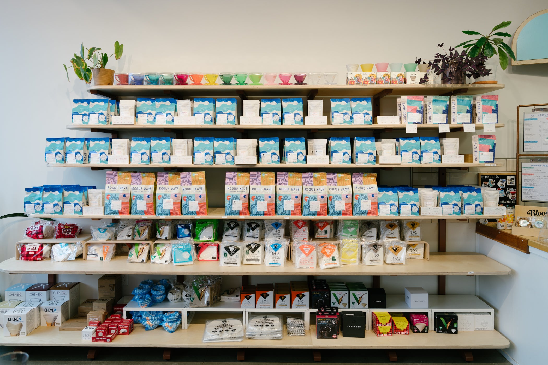 Rogue Wave Coffee shelves stocked with coffee, filter papers, and other gear