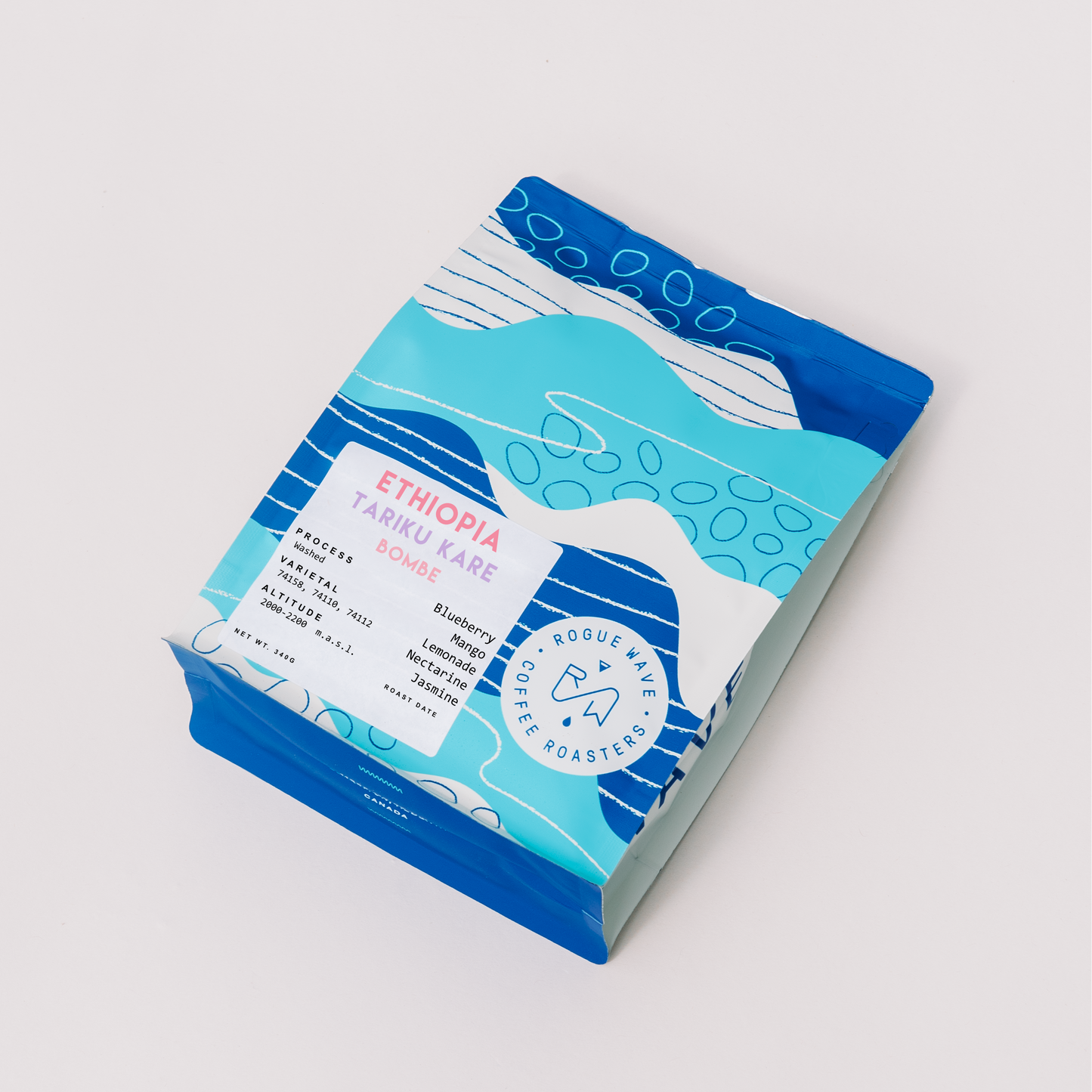 Rogue Wave Coffee packaging with blue and white design on a light gray background