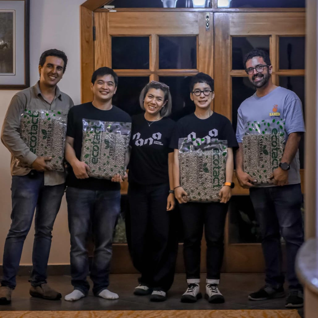 Ply standing in a room with Kent and Kristopher Lamastus, and the Nana team from Thailand