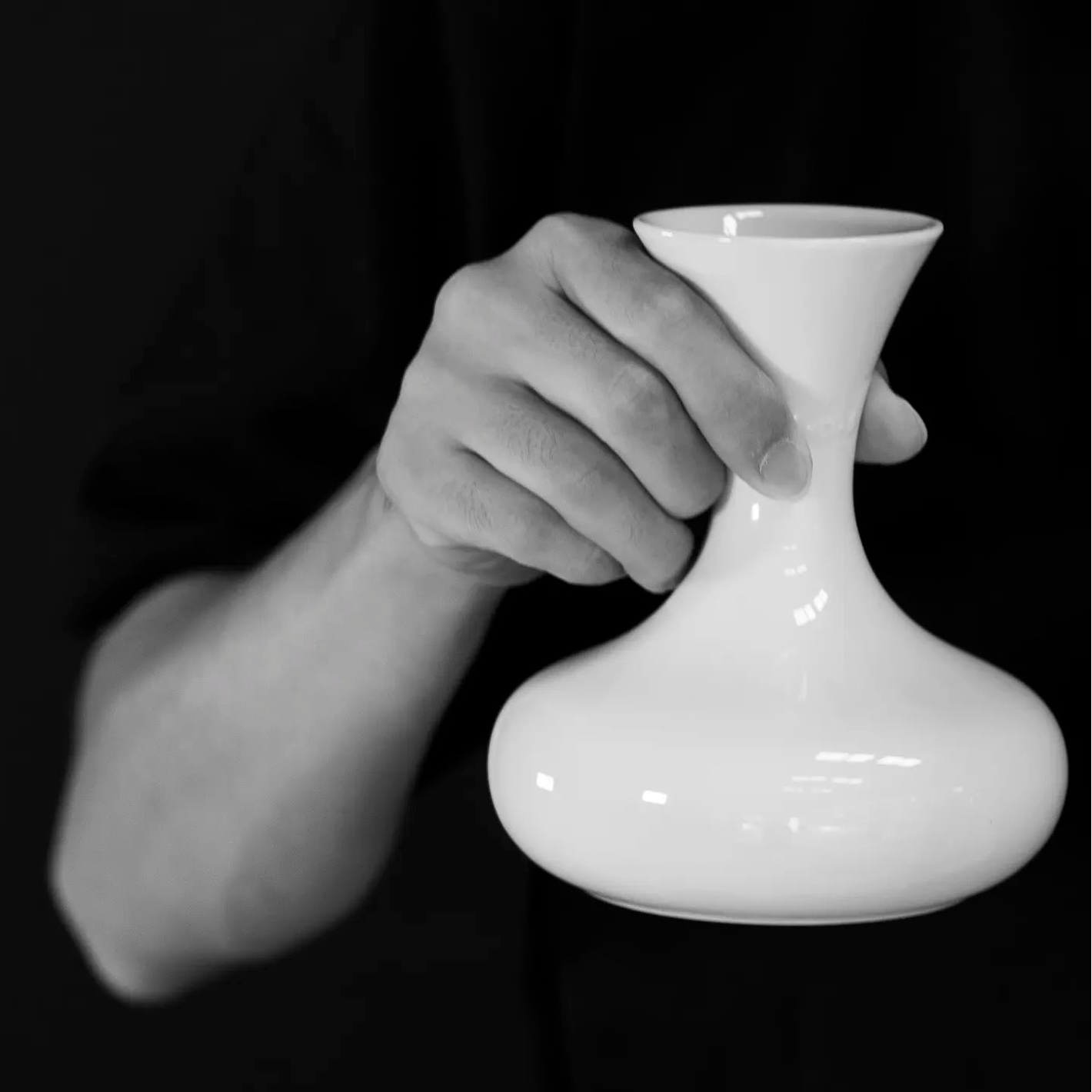 A person holding a TOS Ceramic Carafe