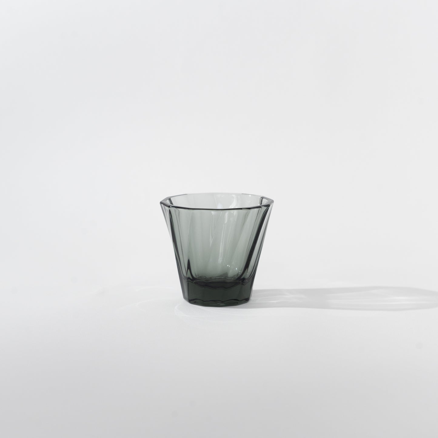 Glass is a great alternative material to our porcelain cups. It is a green, 100% recyclable, strong and non porous material. It has a thickness of 5mm, which retains heat extremely well. It has an interesting twisted exterior that refract light differently, with a curved interior that has the same feature as our porcelain cups. 